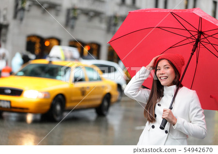 New York City Manhattan woman with fall umbrella New York City Manhattan woman with fall umbrella 54942670