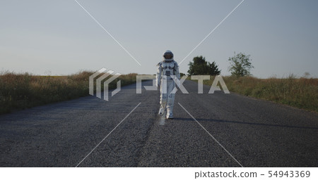 Astronaut walking on road Astronaut walking on road 54943369