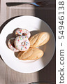 Breakfast of donuts and bread 54946138