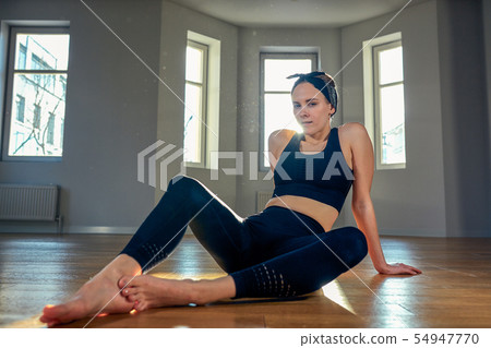 Young Woman Practicing a Yoga Stock Photo - PixelTote