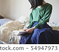 Reading on the bed 54947973