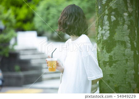 Young woman relaxing outdoors Young woman relaxing outdoors 54949229