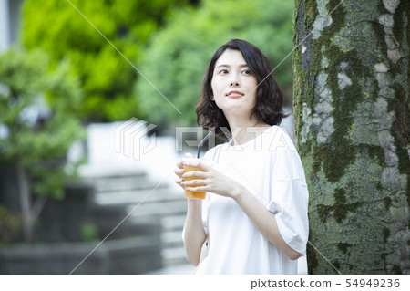 Young woman relaxing outdoors Young woman relaxing outdoors 54949236