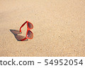 Red sunglasses on the beach 54952054