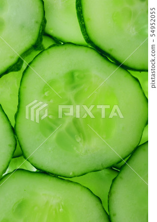 Slices of green fresh cucumber backlit as a 54952055