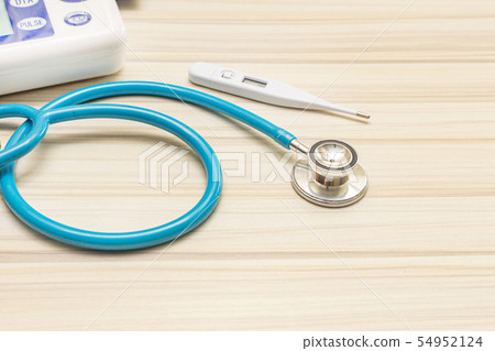The blue stethoscopes on wood table 54952124