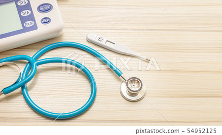 The blue stethoscopes on wood table The blue stethoscopes on wood table 54952125