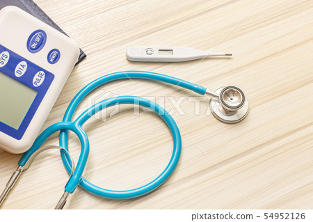 The blue stethoscopes on wood table The blue stethoscopes on wood table 54952126