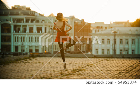 Young woman ballerina standing on the roof - standing on her tiptoe in the pointe shoes and Young woman ballerina standing on the roof - standing on her tiptoe in the pointe shoes and 54953374