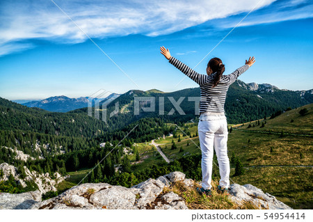 Woman traveler hiking across Croatia landscape. Woman traveler hiking across Croatia landscape. 54954414