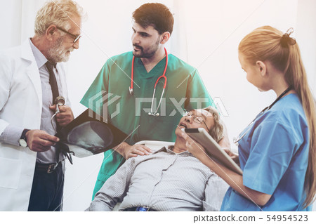Doctor team work with x ray film image of patient. Doctor team work with x ray film image of patient. 54954523