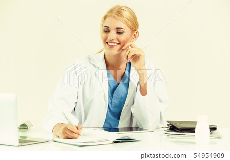 Doctor in hospital working on medical report. Doctor in hospital working on medical report. 54954909