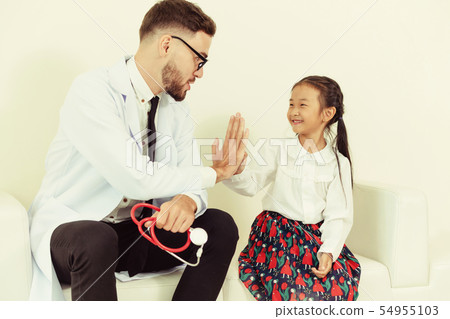 Happy little kid visit doctor in hospital office. 54955103