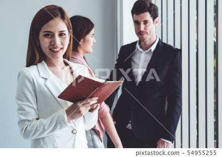 Businesswoman reading book in business office . 54955255