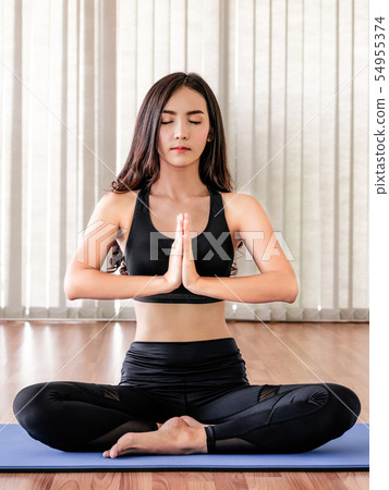 Young woman practice yoga in an gym studio. 54955374