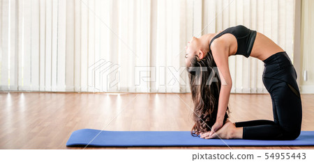 Young woman practice yoga in an gym studio. 54955443
