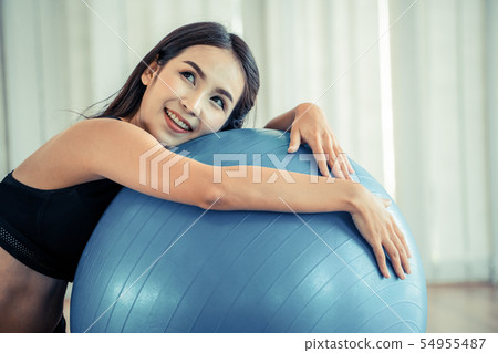 Young woman pilates exercise with fitness ball. 54955487