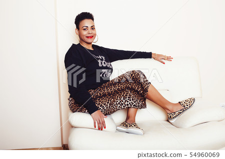 pretty stylish african american big mama woman well dressed. swag relax at home, leopard print on 54960069