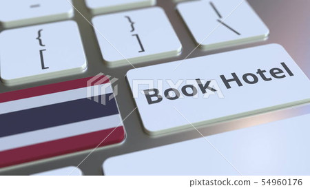 BOOK HOTEL text and flag of Thailand on the buttons on the computer keyboard. Travel related 54960176
