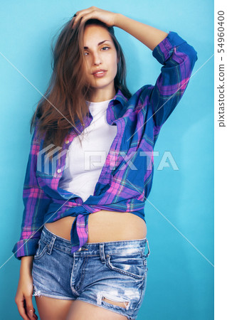 young pretty girl posing happy smiling on blue background, lifestyle people on summer vacation 54960400