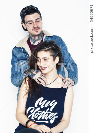 Young couple together. guy with tattoo, girlfriend wearing dreadlocks having fun on white background Young couple together. guy with tattoo, girlfriend wearing dreadlocks having fun on white background 54960671