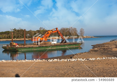 Excavator for channel dredge on a barge. 54960889