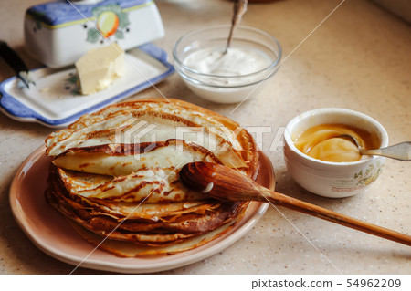 Stack of hot classic Russian thin pancakes. Rustic style. Traditional for the Russian pancake week - Stack of hot classic Russian thin pancakes. Rustic style. Traditional for the Russian pancake week - 54962209