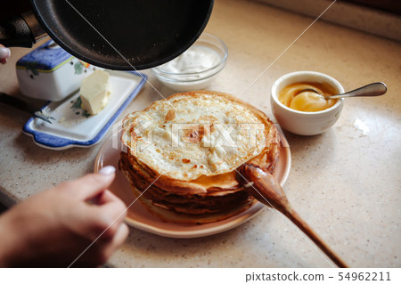 Stack of hot classic Russian thin pancakes. Rustic style. Traditional for the Russian pancake week - Stack of hot classic Russian thin pancakes. Rustic style. Traditional for the Russian pancake week - 54962211