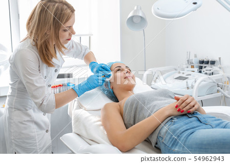 The beautician makes professional rejuvenation 54962943