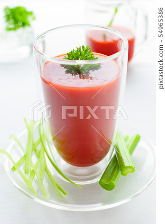 a glass of organic tomato juice, parsley, celery a glass of organic tomato juice, parsley, celery 54965386