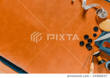 Crafting tools on natural leather on background. 54966647
