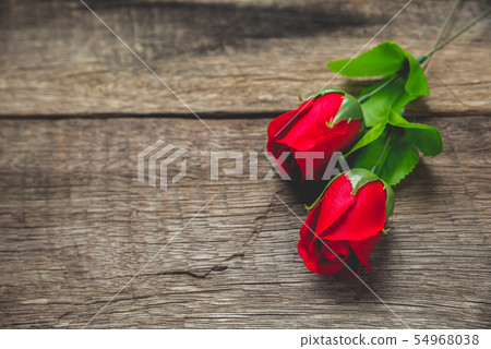 red rose on wood table 54968038
