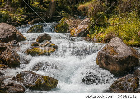 Climbing rocks and large stones flow against the Climbing rocks and large stones flow against the 54968182