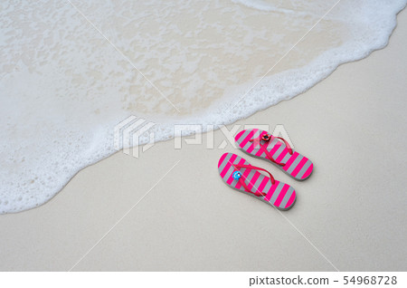 Flip flops on the beach. Flip flops on the beach. 54968728