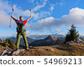 Hiker cheering elated and blissful with arms 54969213