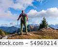 hiker with backpack is stand on mountain top 54969214