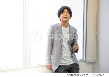 Twenties men sitting by the window Twenties men sitting by the window 54969249