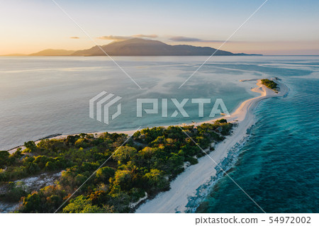 Tropical island at sunset Tropical island at sunset 54972002