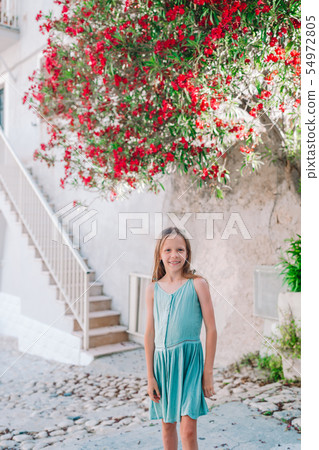 Adorable happy little girl outdoors in european Adorable happy little girl outdoors in european 54972805