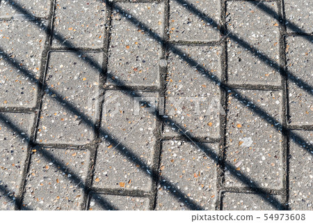 Diagonal shadows on the pavement Diagonal shadows on the pavement 54973608