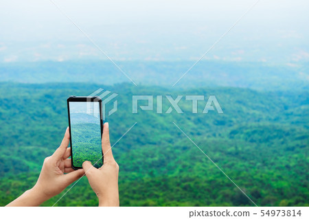 Traveller make photo on smartphone, using phone in Traveller make photo on smartphone, using phone in 54973814