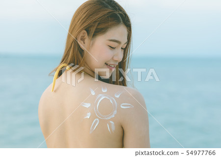 woman smile with healthy skin applying sunscreen woman smile with healthy skin applying sunscreen 54977766