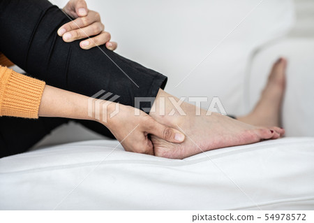 young Asian woman have a ankle pain 54978572