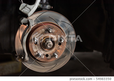 Disc brake and asbestos brake pads at car garage Disc brake and asbestos brake pads at car garage 54983350