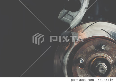 Disc brake and asbestos brake pads at car garage Disc brake and asbestos brake pads at car garage 54983416