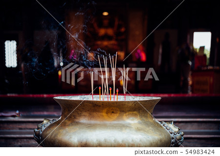 Joss stick or incense sticks burning in temple 54983424