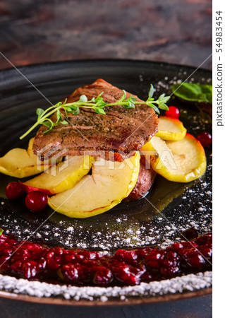 Closeup view of duck breast with apple and currant Closeup view of duck breast with apple and currant 54983454