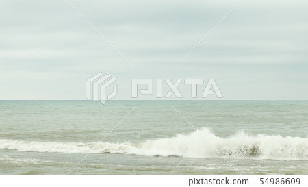 Dark cloudy sky over sea. 54986609