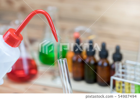Researcher is dropping the reagent into test tube Researcher is dropping the reagent into test tube 54987494