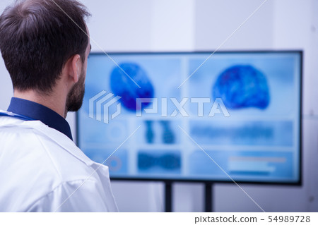 Young male doctor checking his patient brain after surgery 54989728